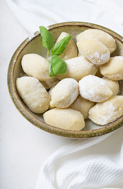 烹饪传统的意大利土豆面食 用罗勒叶 鸡蛋 面粉装饰生面概念粗面粉面粉特写