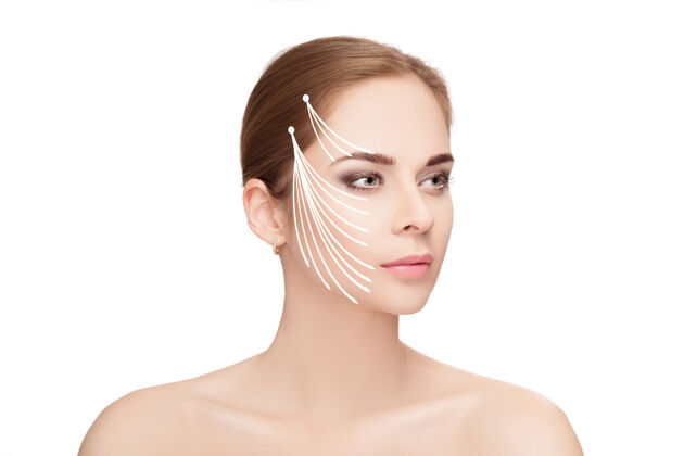 面容水疗肖像迷人的女人与箭头在她的脸上白色背景面举起概念塑料手术治疗 药物医药女人提拉