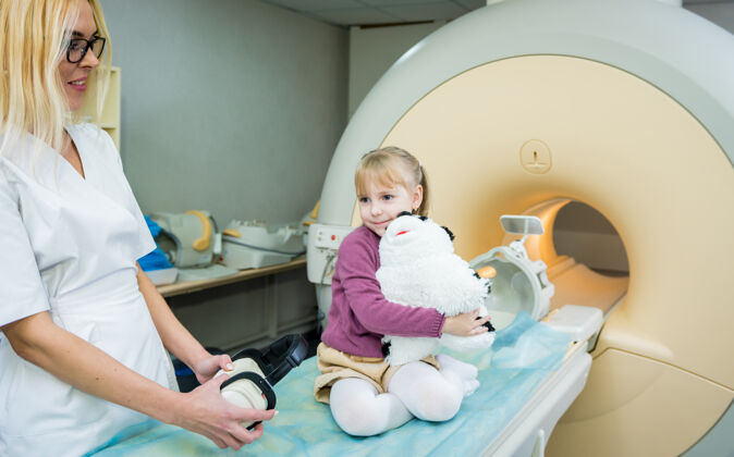放射放射科医生准备给小女孩做核磁共振脑部检查放射医疗保健健康
