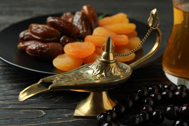 伊斯兰教斋月的概念与食物和配件的木桌上卡里姆枣水果