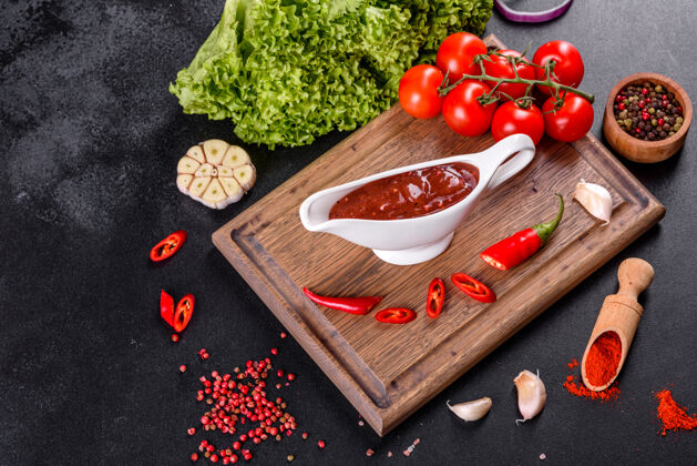 辣椒格鲁吉亚菜的辛辣调味料阿吉卡在一个碗里 用红辣椒和大蒜放在混凝土桌上特写镜头新鲜自然调味品