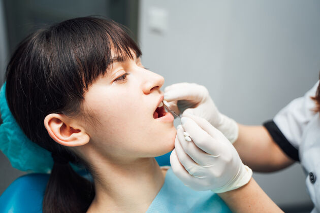 年轻漂亮的年轻女子在口腔诊所做牙齿检查卫生健康治疗
