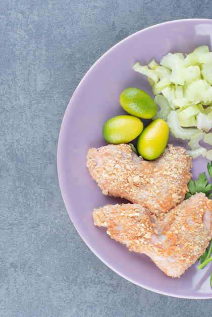 小吃紫色盘子上的生鸡翅块烹饪烘焙食谱