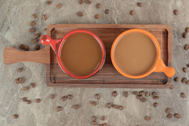 烤在木板上放两杯咖啡和咖啡豆香味豆