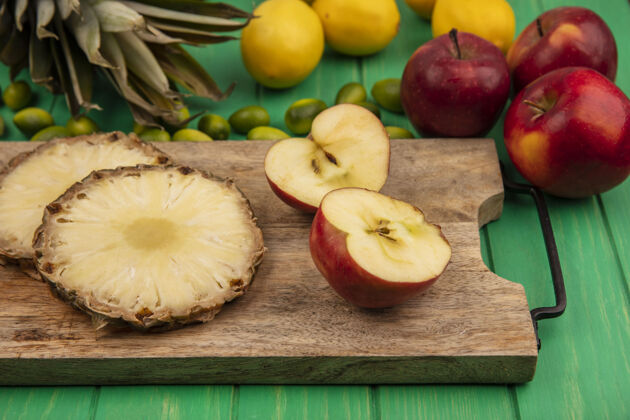 金盏花新鲜水果的俯视图 如苹果和菠萝隔离在木制厨房板上 金冈红苹果和柠檬隔离在绿色木制背景上饮食水果红色