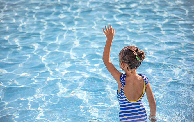 女孩可爱的小女孩在清澈的水中游泳洗澡游泳池童年