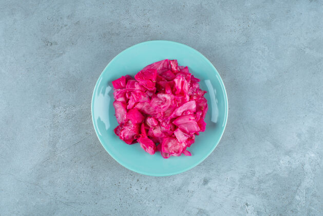 发酵红色发酵泡菜放在蓝色的盘子里自制罐头盘子