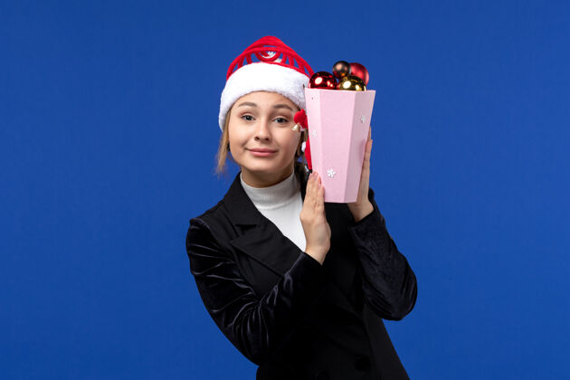 工程师正面图蓝色背景上手持圣诞树玩具的年轻女性感慨新年假期职业人举行