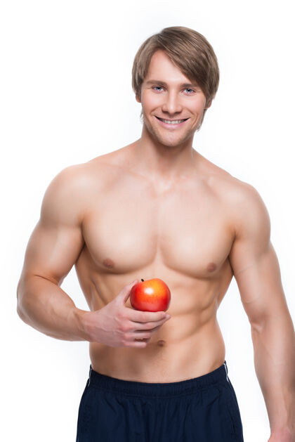 苹果年轻微笑的健美运动员手拿苹果的画像胡须牙齿肌肉