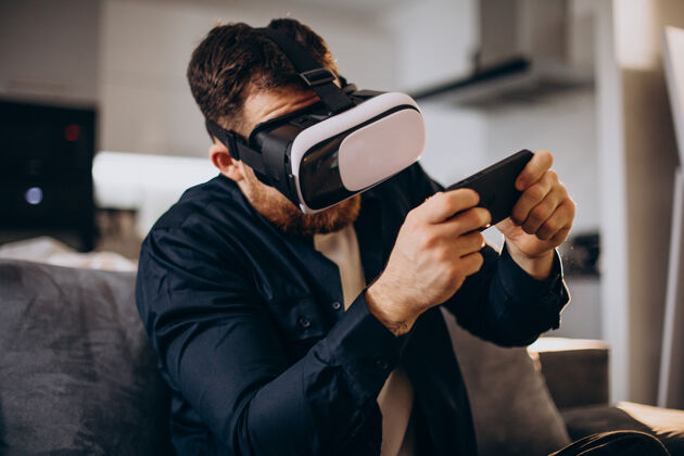 游戏坐在家里使用虚拟现实的男人小工具模拟高科技