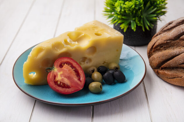 橄榄前视图玛斯丹奶酪与西红柿和橄榄在蓝色盘子上白色背景食物前面马斯丹