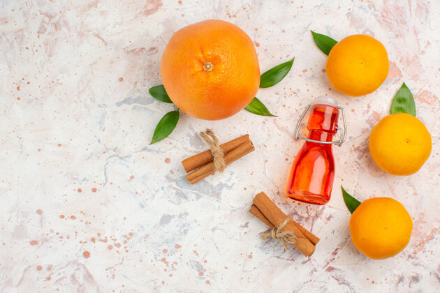 顶部顶视图新鲜橘子肉桂棒橘子瓶在明亮的表面自由的地方柑橘多汁瓶子