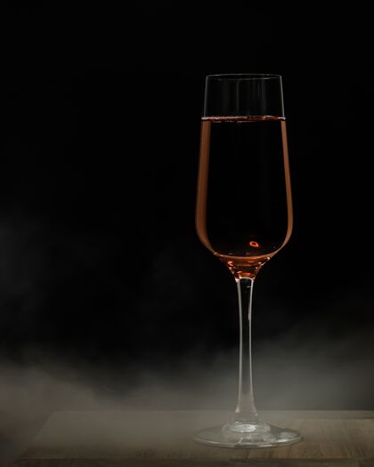 酒垂直选择性聚焦拍摄一杯香槟在木制表面和黑色距离庆典水果长笛