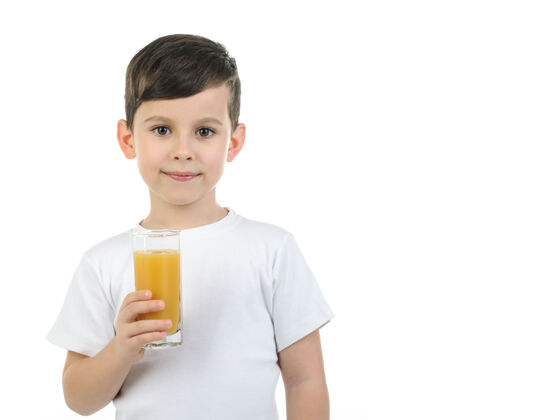 白色一个穿着白色t恤的6岁男孩拿着一个玻璃杯 玻璃杯上放着柑橘汁背景隔离背景小学时代白种人酒杯