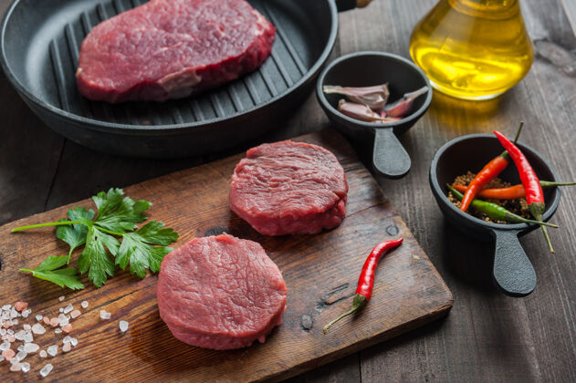牛排新鲜的生肉放在木砧板上食物烹饪烧烤