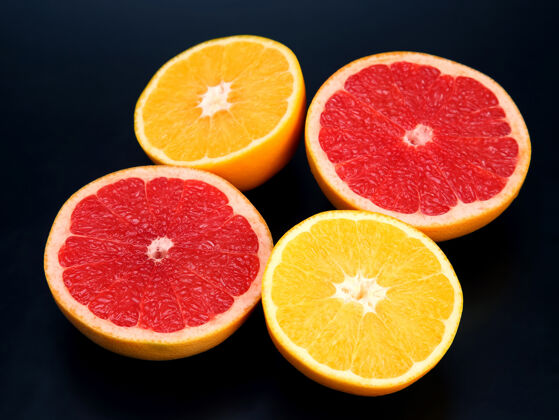切片在深色的背景上切块不同的柑橘类水果甜点甜味葡萄柚