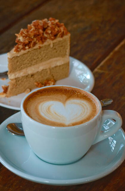 零食热拿铁艺术咖啡与咖啡蛋糕背景木头美味浓缩咖啡