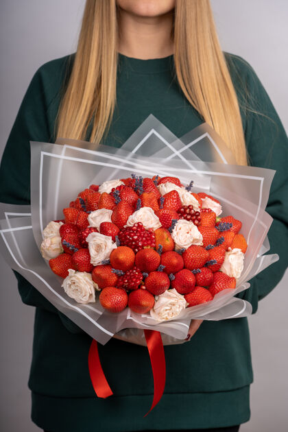 花女人手里捧着一束草莓和玫瑰组合水果花束