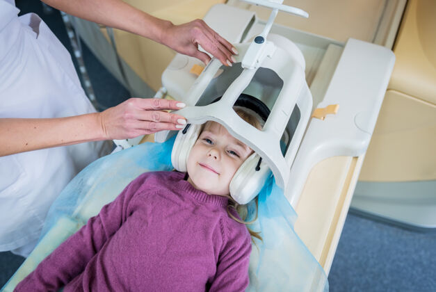 专业放射科医生准备给小女孩做核磁共振脑部检查女性妇女X光