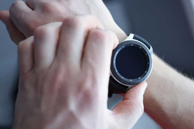 通话男人的手戴着黑色智能手表时钟健康脉搏