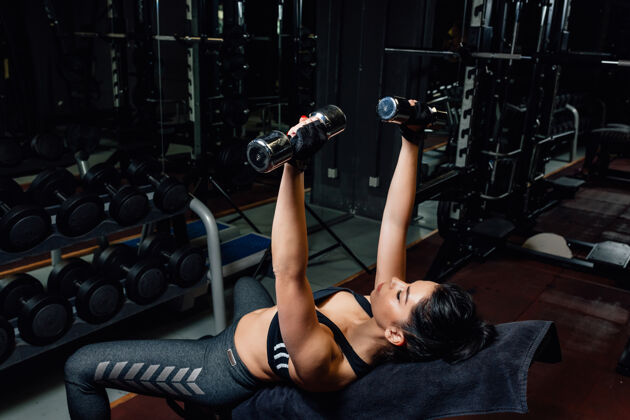运动员健身女在健身房进行壶铃训练运动身体体重