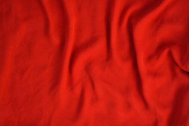 软鲜红色无缝织物的皱褶纹理桌布纺织品压碎