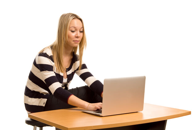 笔记本电脑穿着黑白条纹上衣的时髦金发女郎在笔记本电脑上工作女人工作人