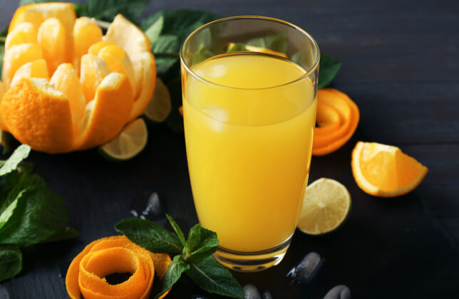 美味一杯美味的橙汁和配料放在平板上切片素食刷新