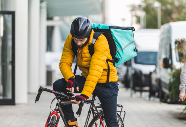 工作送菜服务 骑手用自行车送菜给客户-关于交通 送菜和技术的概念城市房子餐馆
