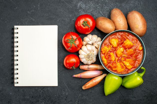 健康俯瞰美味的鸡肉片和番茄酱和蔬菜在深灰色的背景酱菜鸡肉番茄肉新鲜食品顶部
