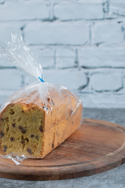 糕点一块用塑料薄膜包在木板上的馅饼面粉脂肪美味