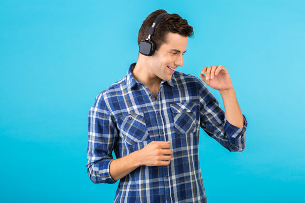 积极坐在蓝色耳机上听音乐的男人的画像表情自信聚会