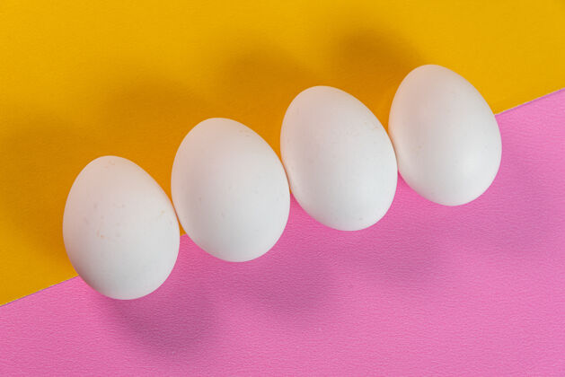 极简蛋在黄色和粉色的表面营养动物蛋美食家