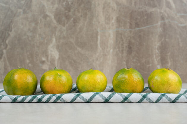 美味条纹桌布上的一束绿橘子膳食食品营养