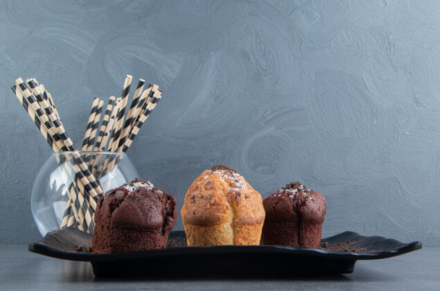 零食黑木板上的巧克力松饼和坚果松饼自制食品蛋糕