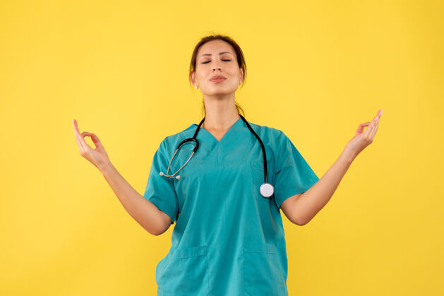 视图前视图穿着医用衬衫的女医生在黄色背景上冥想女医生情绪成人