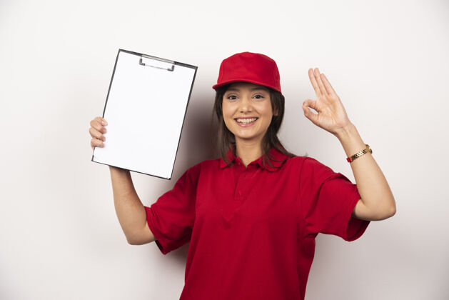 女性一个穿着红制服 带着空剪贴板的积极女人女士人制服