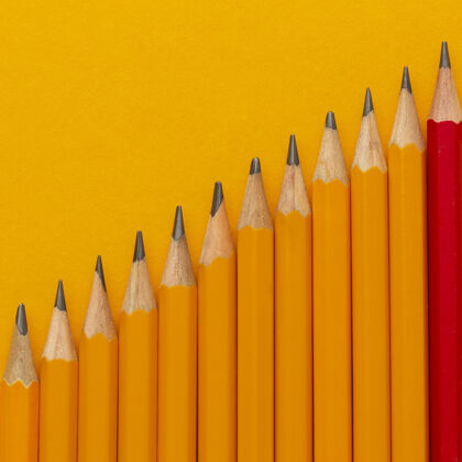 分类把铅笔平放在橙色的背景上图形平面布局概念