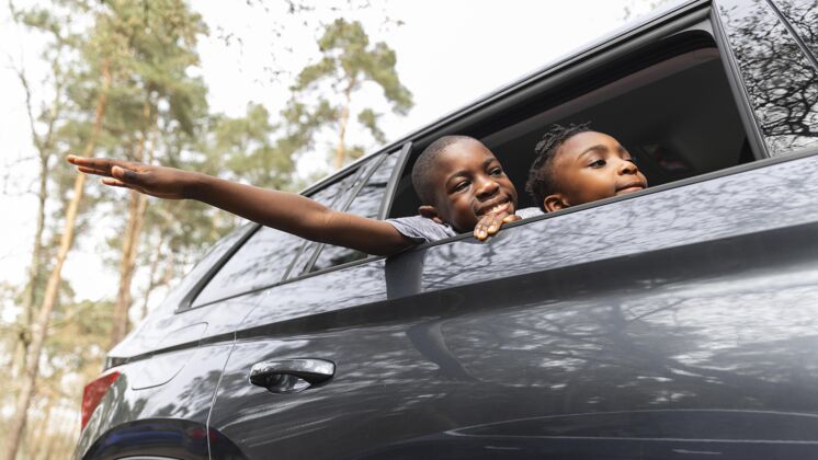 家庭孩子们从车窗往外看冒险度假旅游
