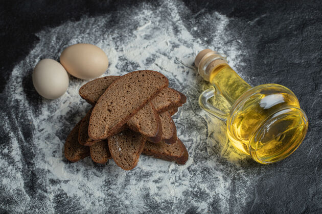 木材乡村风格切片的棕色面包 面粉背景上有鸡蛋和油选择性聚焦耐嚼切割