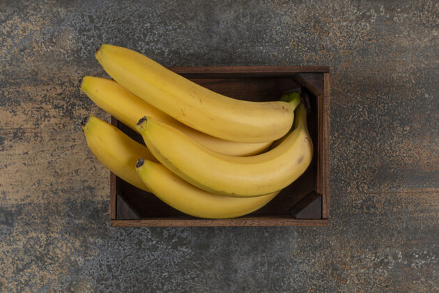 新鲜成熟的香蕉在盒子里 在大理石表面香蕉成熟可口