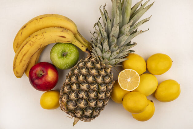 水果俯瞰美味的水果 如香蕉菠萝五颜六色的苹果和柠檬隔离在白色的墙壁上美味香蕉菠萝