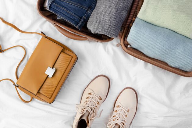 度假打开的行李和折叠的衣服和鞋子顶视图旅李
