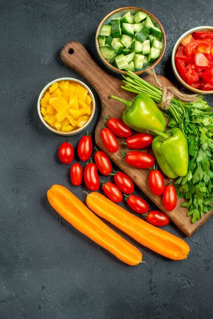 洋葱在深灰色背景下 盘子架的顶视图 上面和旁边都是蔬菜番茄蔬菜食物