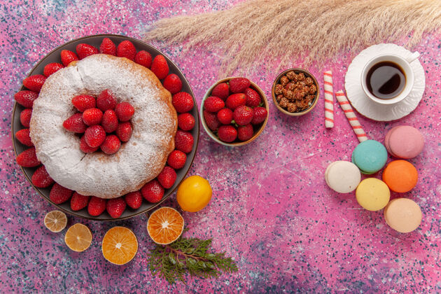清淡顶视图糖粉派草莓蛋糕与茶和麦卡龙粉红蛋糕麦卡龙饮食