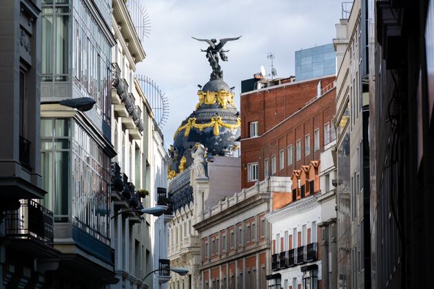 天空特写镜头与维多利亚雕像圆顶 大都会大厦 马德里 西班牙城市景观正面观点