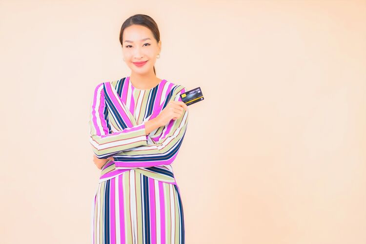 欢呼用智能手机和彩色信用卡描绘美丽的亚洲年轻女子消费者亚洲金融