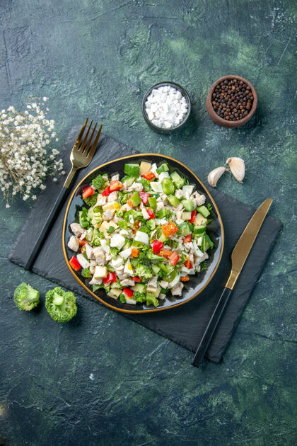 烹饪顶视图美味的蔬菜沙拉在深蓝色背景上的盘子里烹饪餐厅新鲜的饭菜颜色健康的午餐食物饮食饮食午餐美味