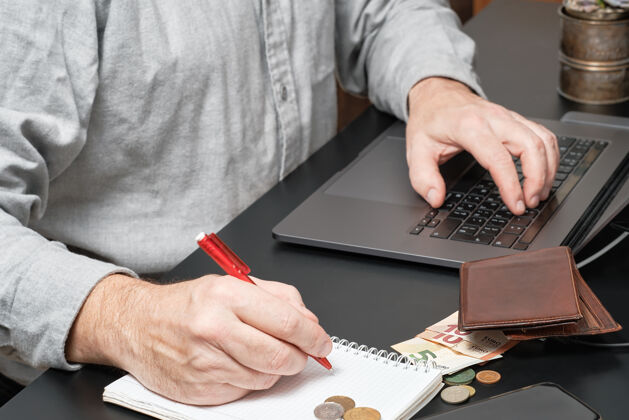 计划商人或会计拿着笔在办公桌上用笔记本电脑计算财务报告电子邮件债务检查