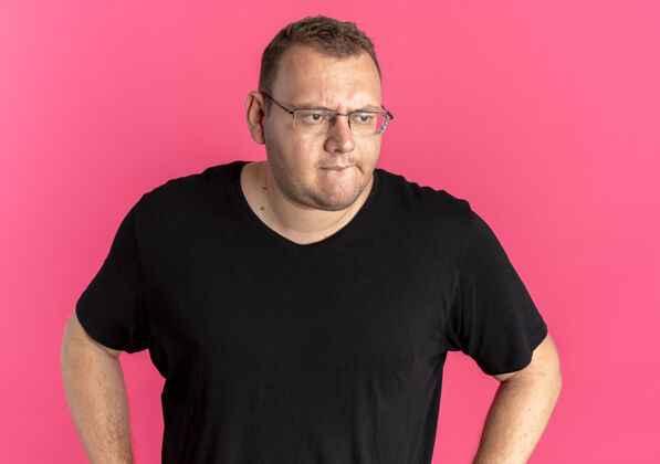 拼图一个戴眼镜的胖男人穿着黑色t恤 一边看一边困惑地看着粉色站立眼镜靠边站